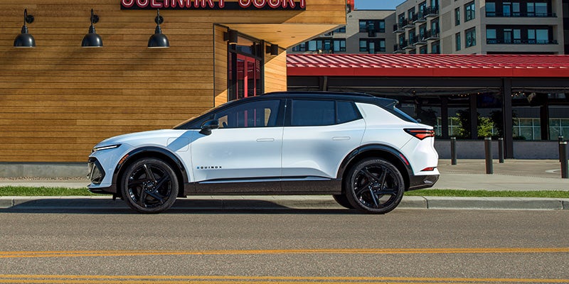 Side view of 2026 Chevrolet Equinox EV in Bakersfield highlighting aerodynamic design, sleek lines, and modern electric SUV styling.