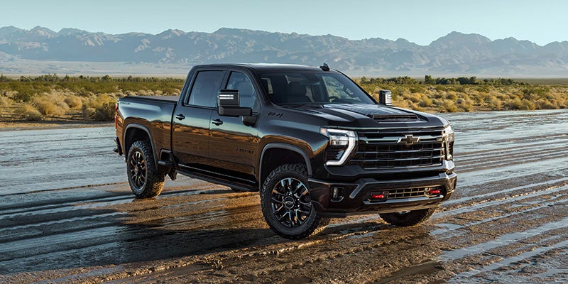 Chevrolet Silverado pickup truck parked near mountains and water
